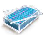 A clear acrylic display box with a removable lid. The acrylic box stores The Mahjong Line mahjong tile set.