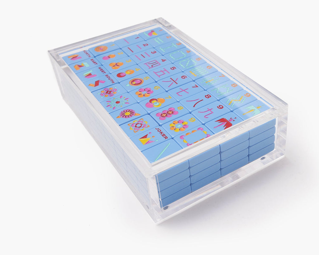 A clear acrylic display box with a removable lid. The acrylic box stores The Mahjong Line mahjong tile set. 