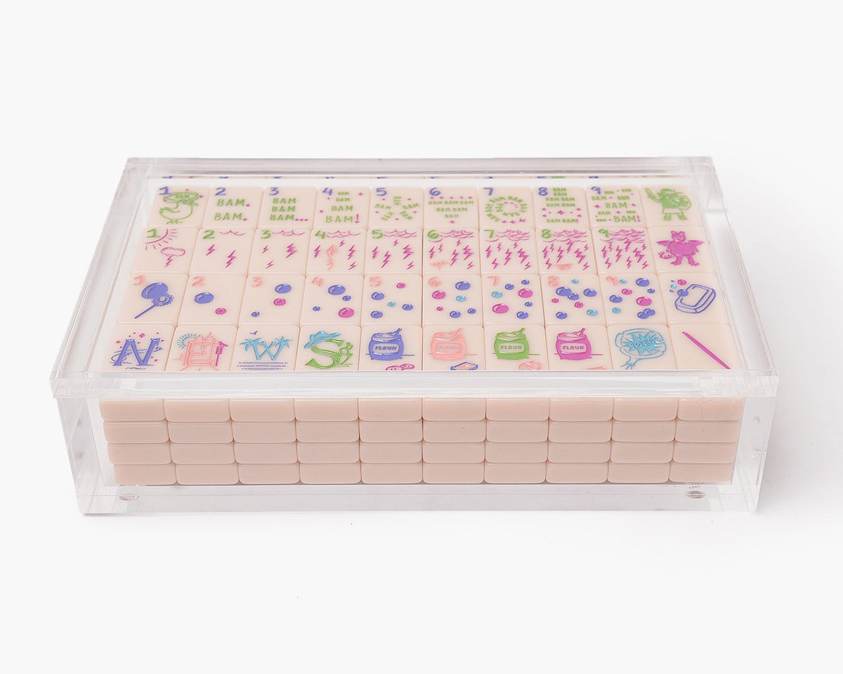 A clear acrylic display box with a removable lid. The acrylic box stores The Mahjong Line mahjong tile set.