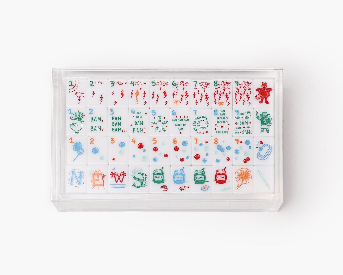 A clear acrylic display box with a removable lid. The acrylic box stores The Mahjong Line mahjong tile set.