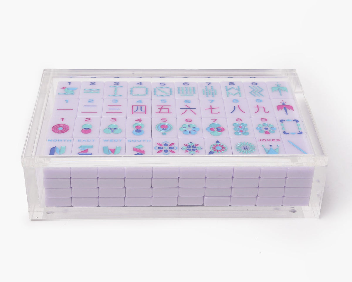 A clear acrylic display box with a removable lid. The acrylic box stores The Mahjong Line mahjong tile set.