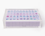 A clear acrylic display box with a removable lid. The acrylic box stores The Mahjong Line mahjong tile set.