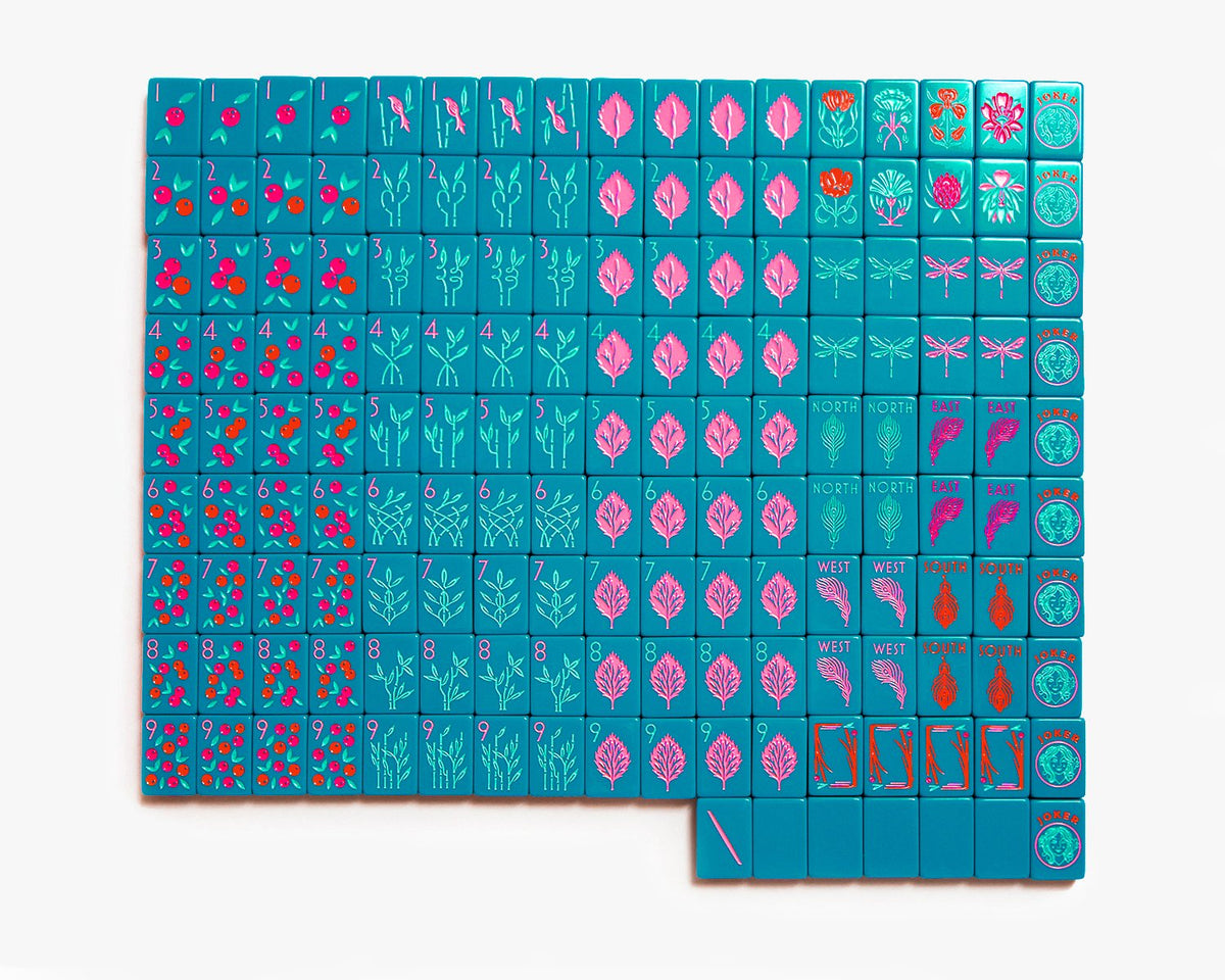 American Mahjong Tile Set to play the game of mahjong. Custom mahjong set is called the botanical line featured in a deep teal. The set comes with a field guide for quick mahjong rules. The set comes with a canvas mahjong tile bag for quick storage.