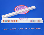 White painted wooden Mahjong rack and pushers placed on top of a Mahjong mat. The racks and pushers are custom made for our mahjong sets for sale.