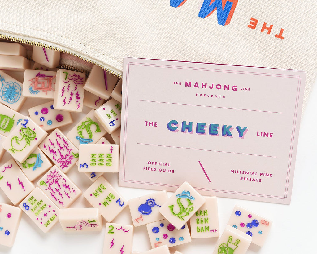 American Mahjong Tile Set to play the game of mahjong. This custom mahjong set is called the cheeky line featured in a millennial pink. The set comes with a field guide for quick mahjong rules. The set comes with a canvas mahjong tile bag for quick storage. 
